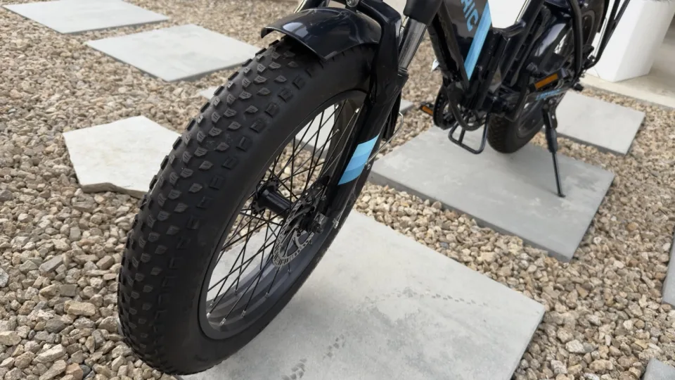 Front 20 by 3-inch tire, wheel, fender, and suspension fork on the Lectric bike