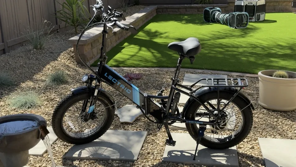 Full side view of the black and blue Lectric XP Step-Thru 2.0 in sunlight